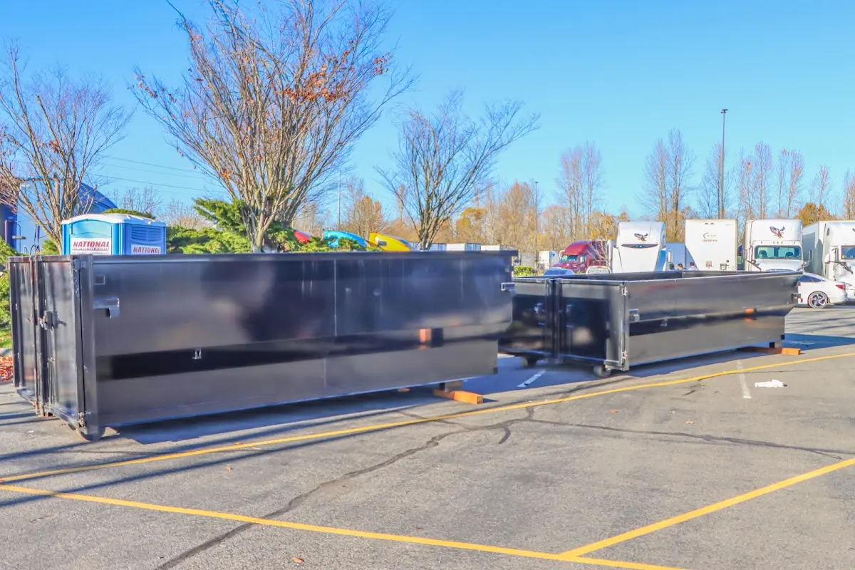 Professional dumpster rental service with roll-off container on residential driveway in East Haven